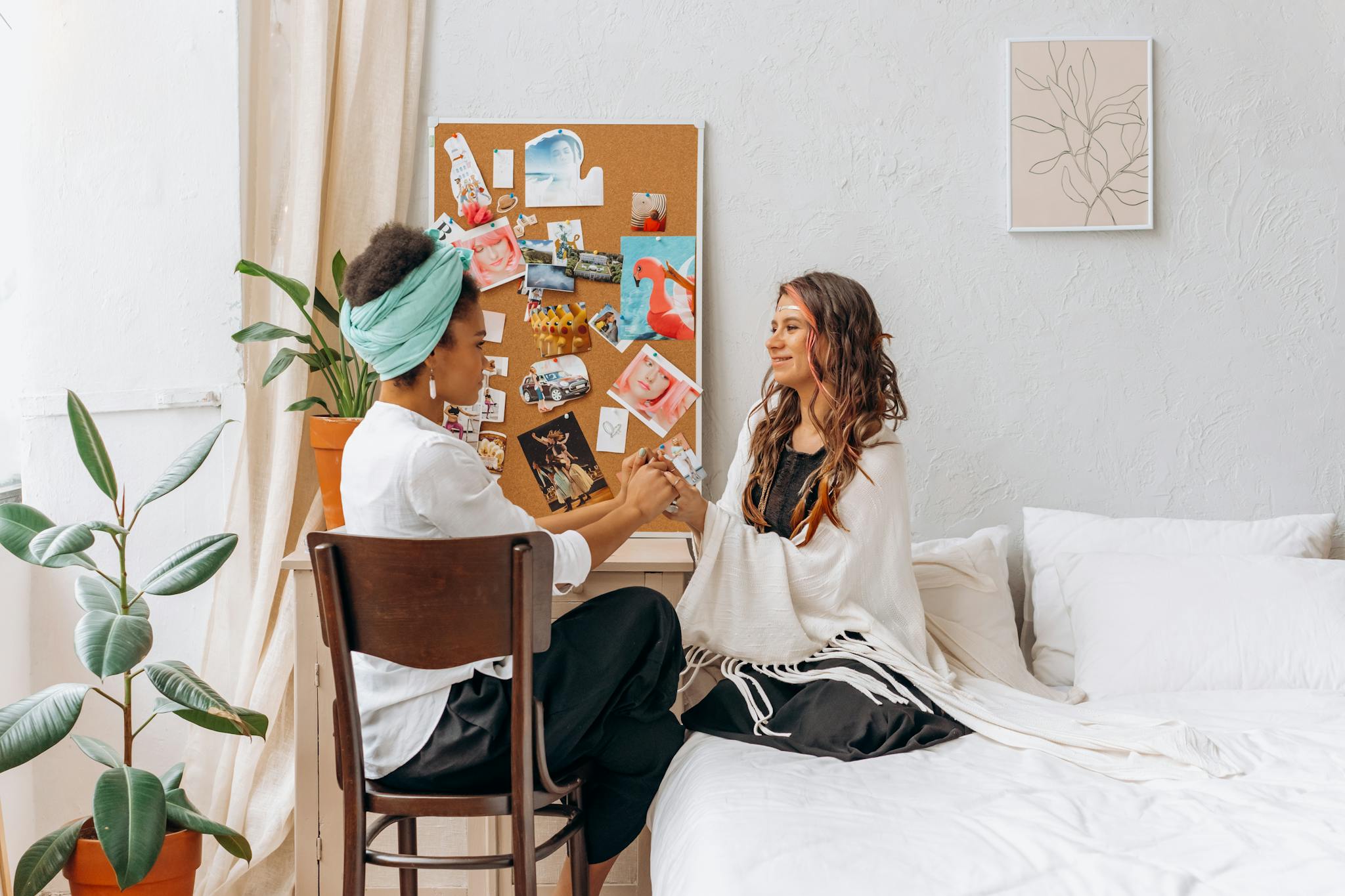 Woman in White Long Sleeve Shirt Sitting on Bed